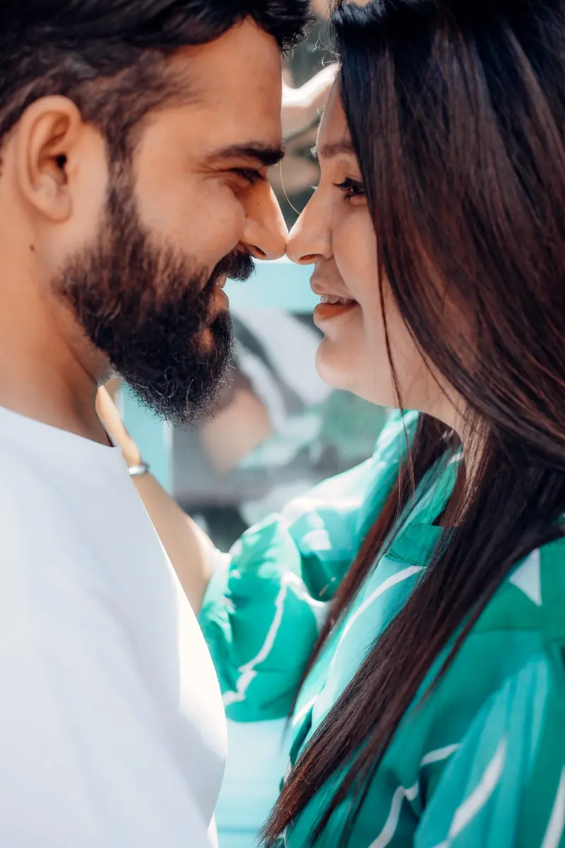 Close candid portrait of a couple laughing forehead to forehead during a pre-wedding session