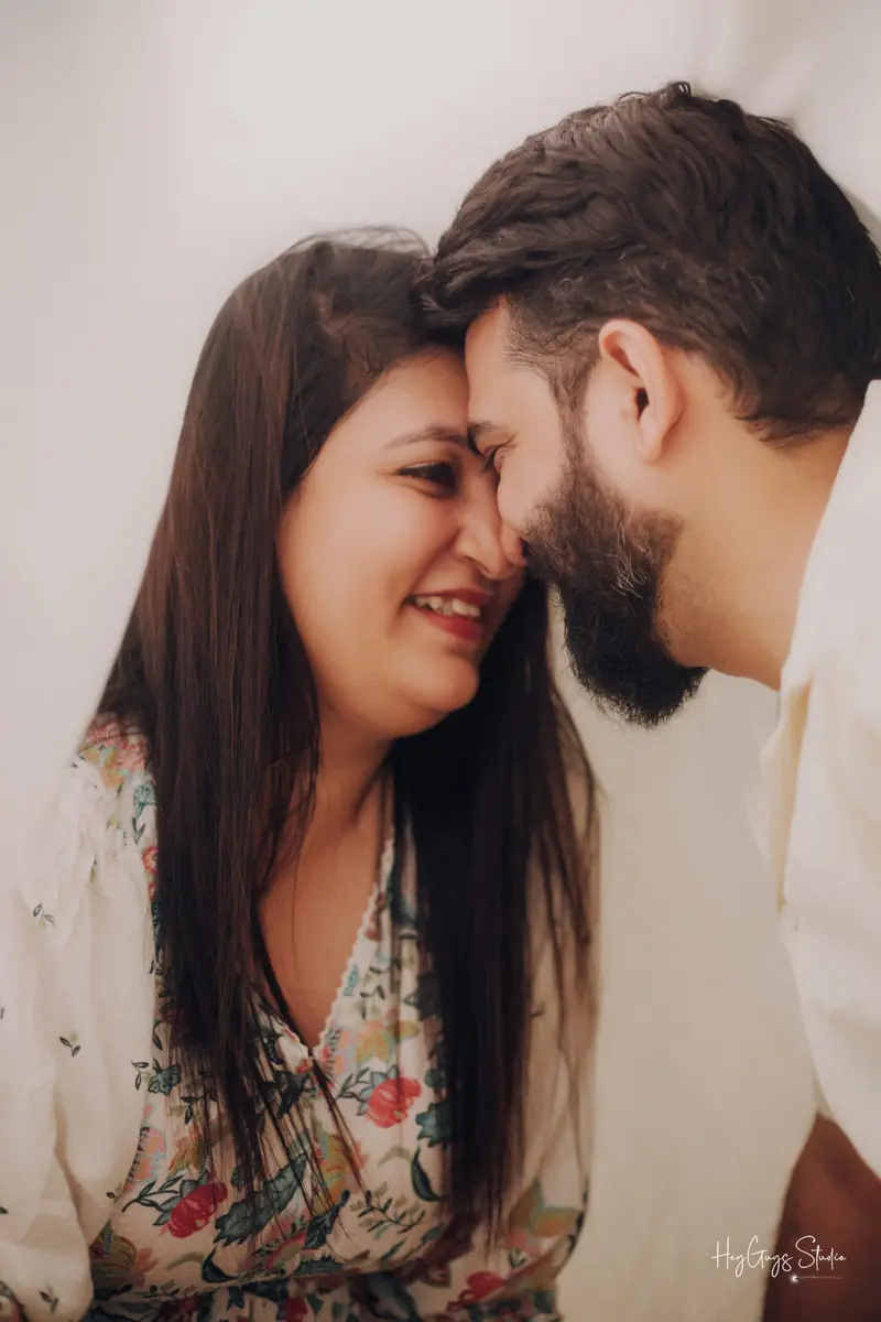 Soft-light close portrait of a couple smiling together during a pre-wedding session