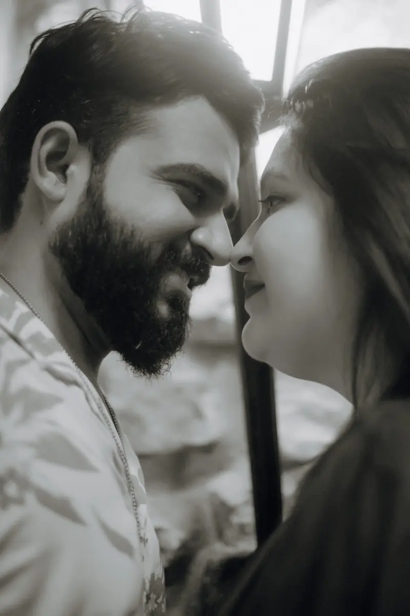 Black and white portrait capturing a quiet moment of closeness between a couple